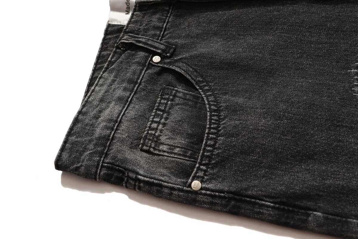 JUSTNOTAG Jeans a zampa micro svasata con lettere sfrangiate
